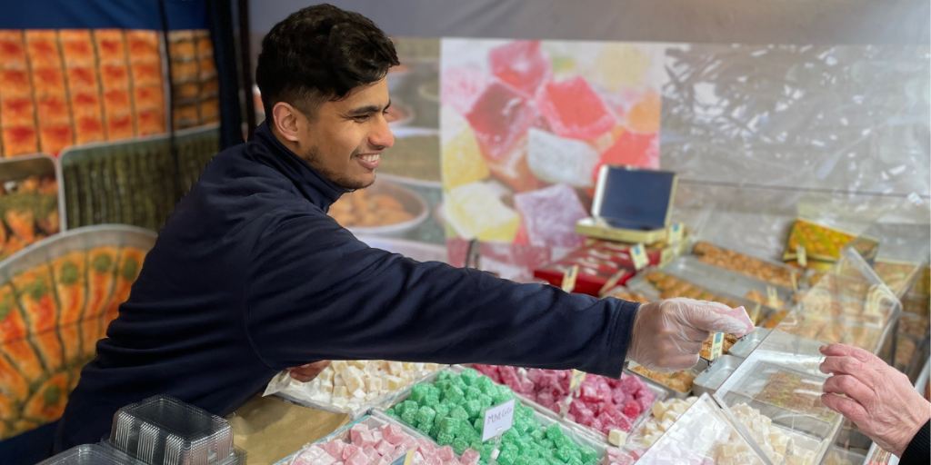 International Market trader serving customer International Market trader serving customer
