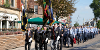 Army representatives marching through Preston carrying flags