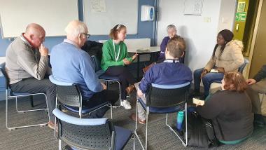 A group of people sat around talking about change within climate change.