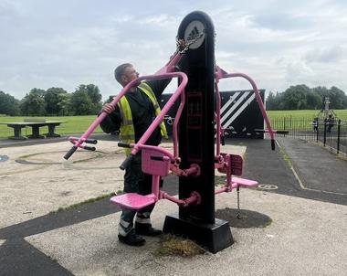 Park Ranger fixing exercise equipment