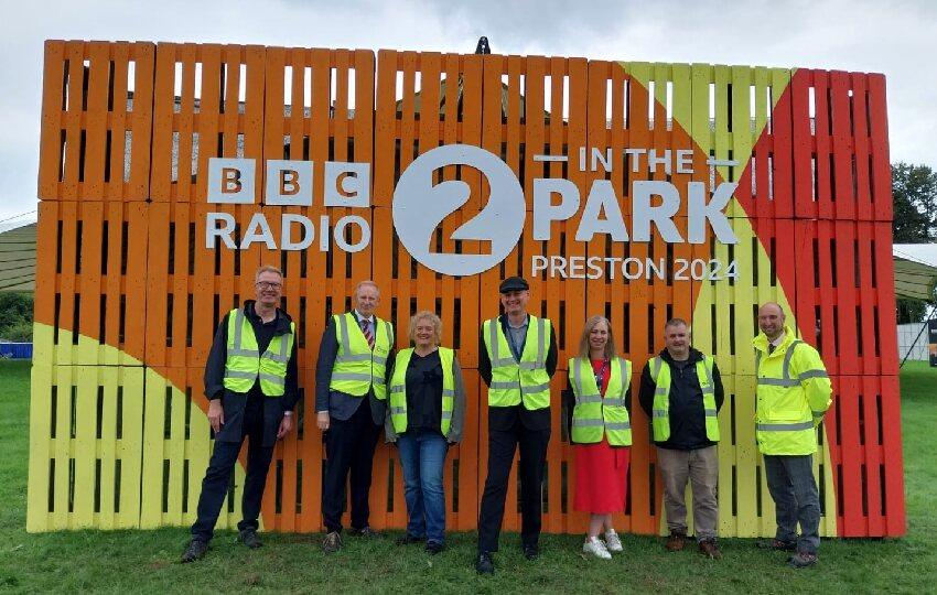 Preston City Council staff infront of Radio 2 in the Park sign