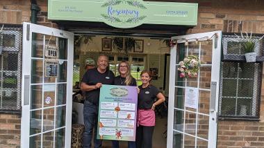 Rosemary in the Park cafe and staff holding their Radio 2 in the Park special menu