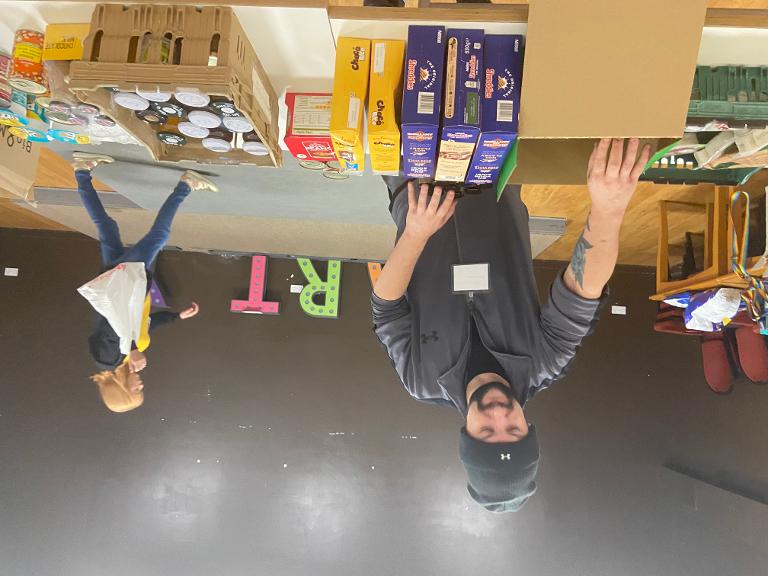 Volunteer preparing food parcels at Ashton Food Hub