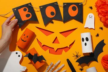 Paper decorations for Halloween on orange background